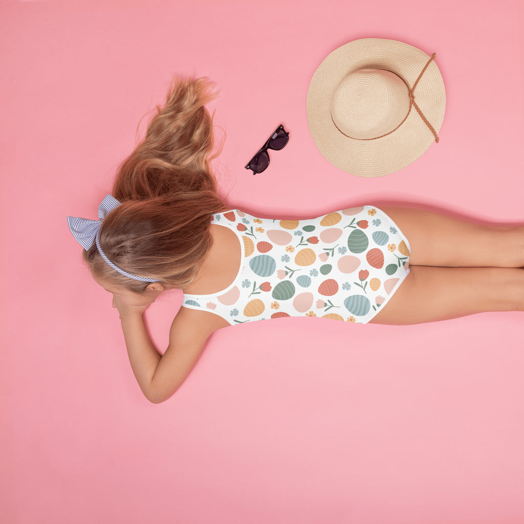 Girls pastel Easter egg pattern white one-piece swimsuit with buttery soft fabric and UPF 50 plus double layered front