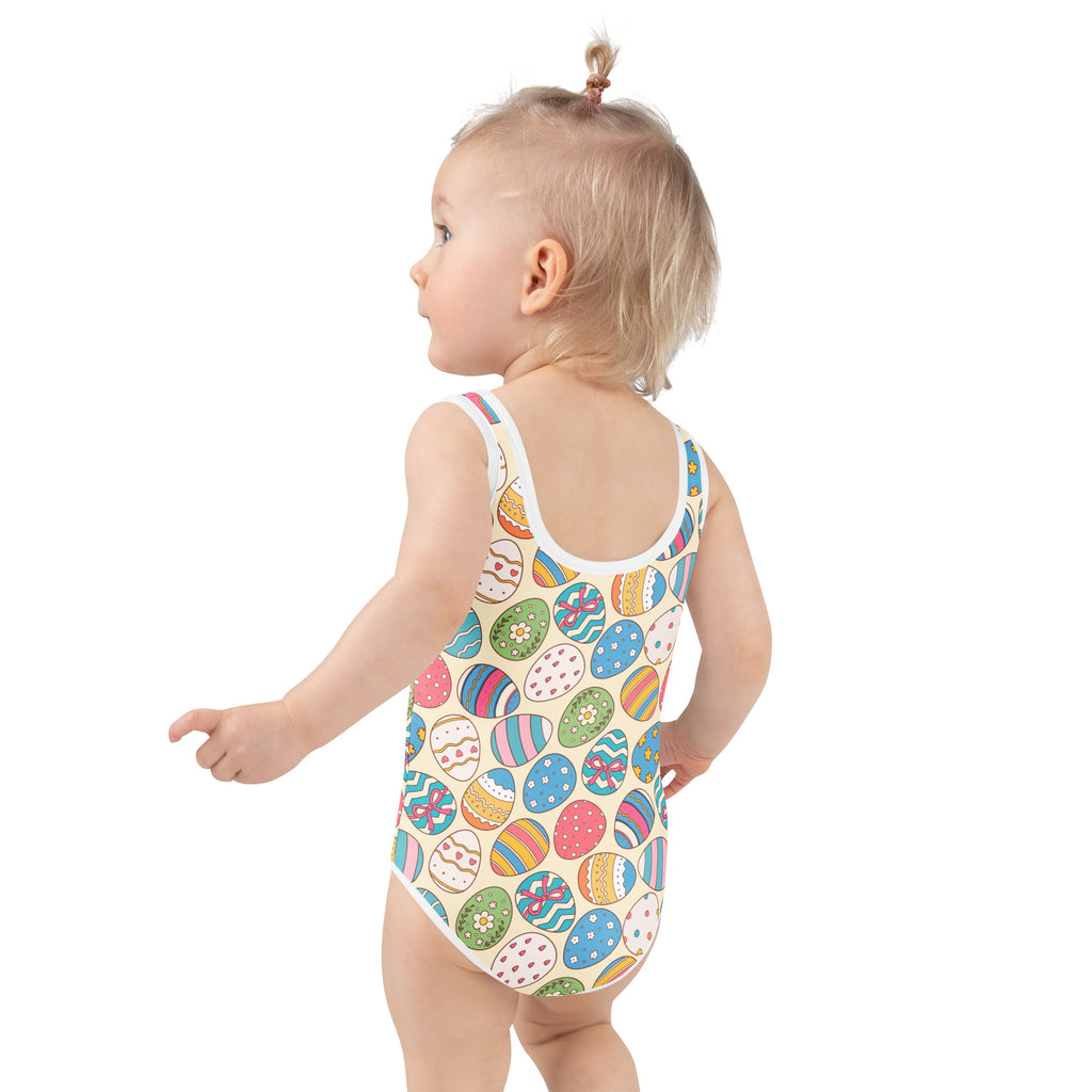 A child wearing a beige girls colorful easter eggs pattern buttery soft swimsuit with UPF 50+ and double layered front