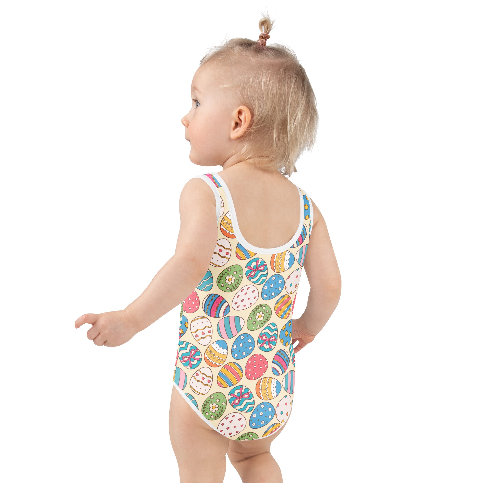 A child wearing a beige girls colorful easter eggs pattern buttery soft swimsuit with UPF 50+ and double layered front