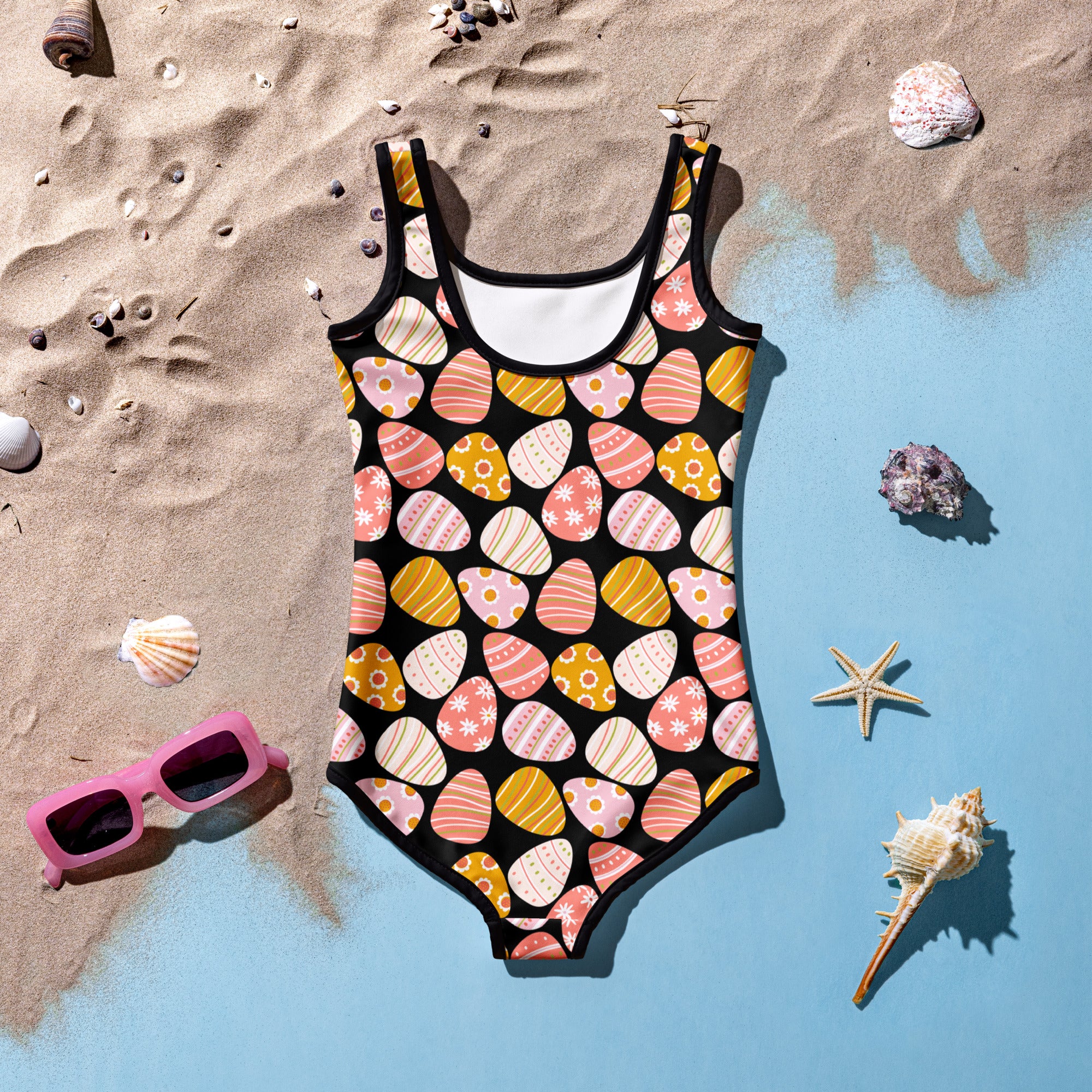 A black girls one-piece buttery soft swimsuit with pastel pink peach and yellow Easter egg patterns UPF 50 plus