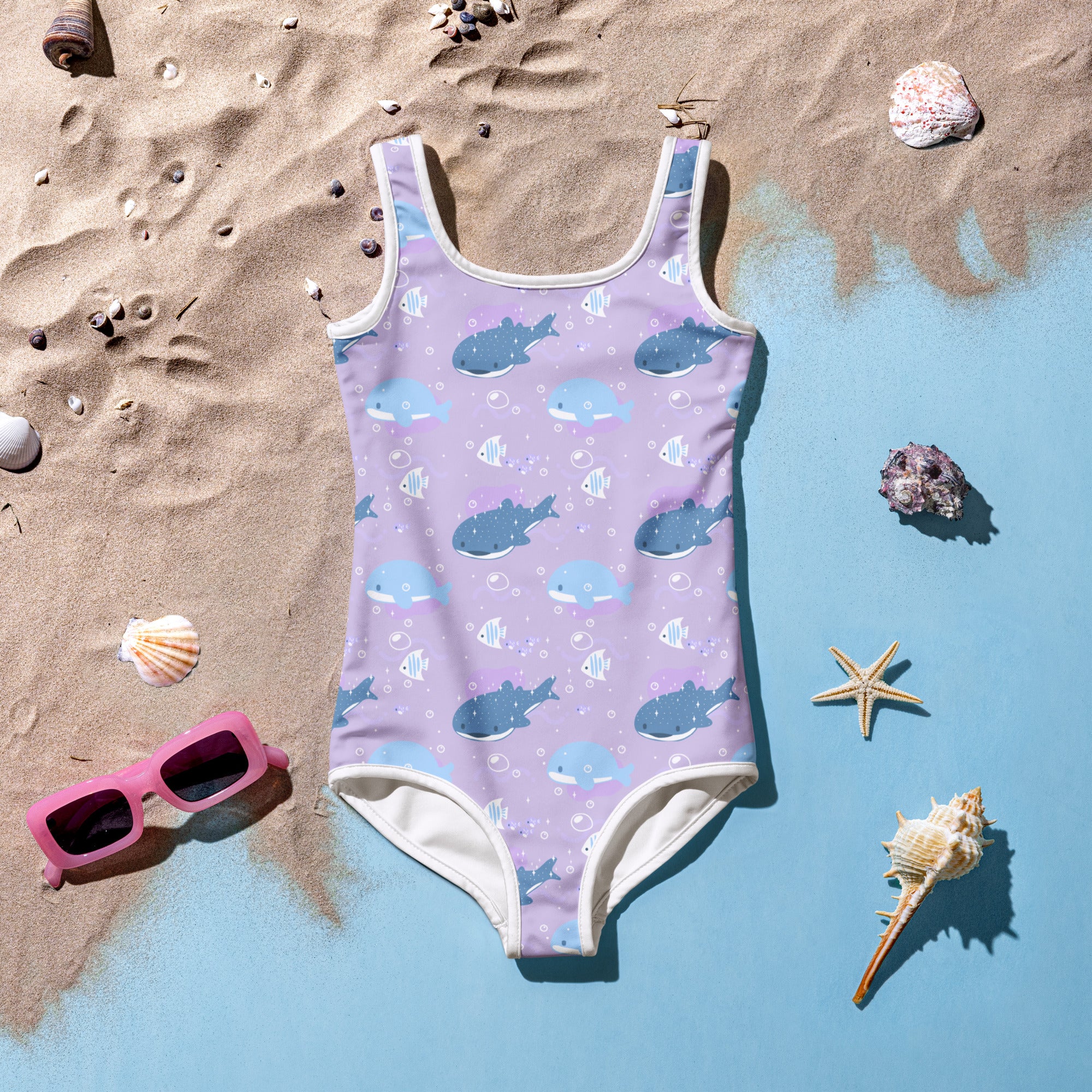 Girls purple whale shark buttery soft swimsuit with UPF 50 plus featuring playful blue whale and fish pattern and white trim