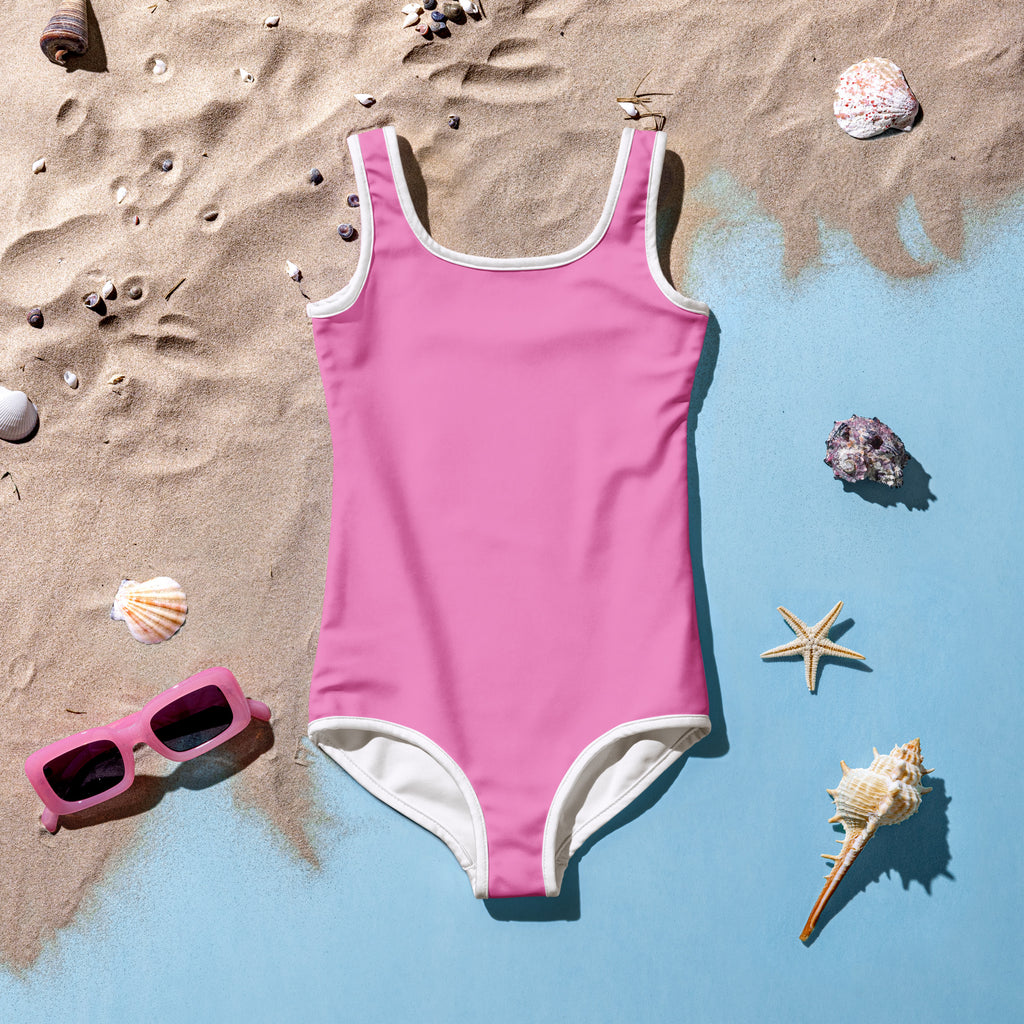 Girls buttery soft pink one-piece swimsuit with white trim and UPF 50 plus sun protection