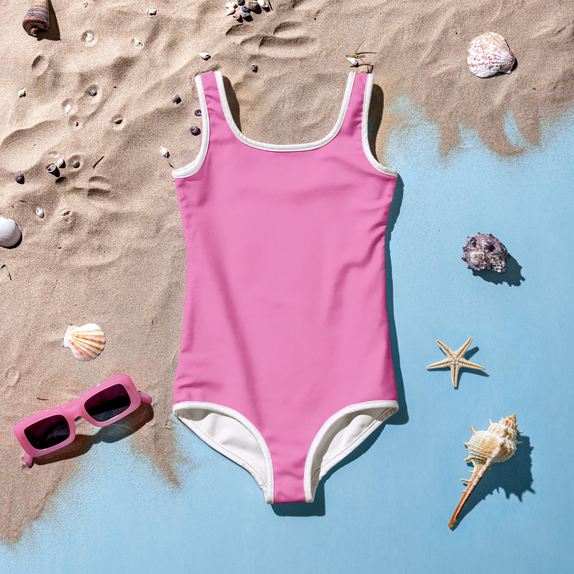 Girls buttery soft pink one-piece swimsuit with white trim and UPF 50 plus sun protection