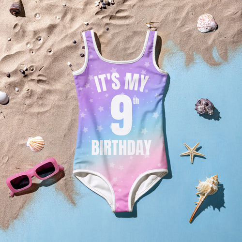 Girls custom age it’s my birthday swimsuit with vibrant purple to pink ombre, white stars, and bold white text