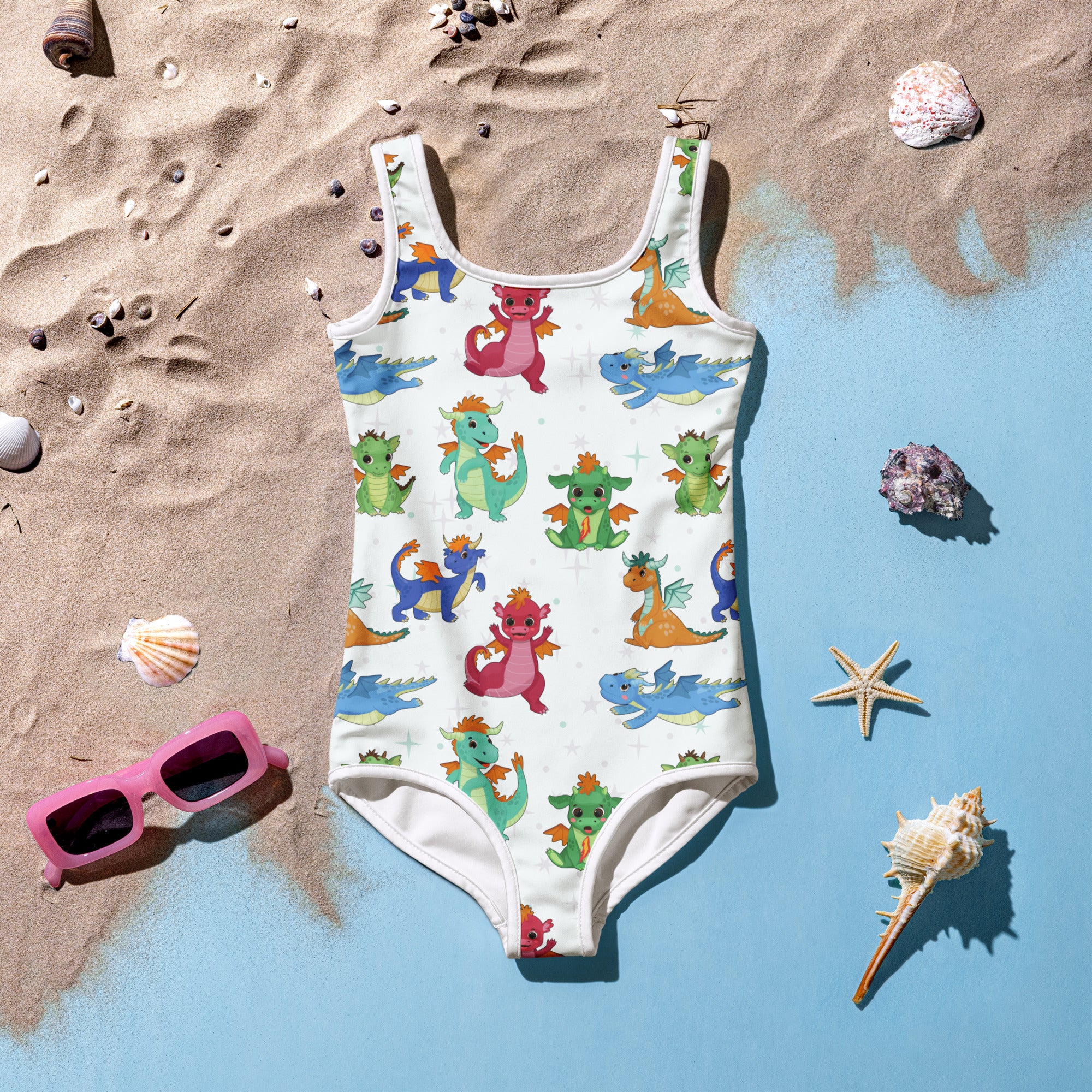 A white one-piece girls swimsuit with colorful cartoon dragons made of buttery soft fabric with upf 50+ protection