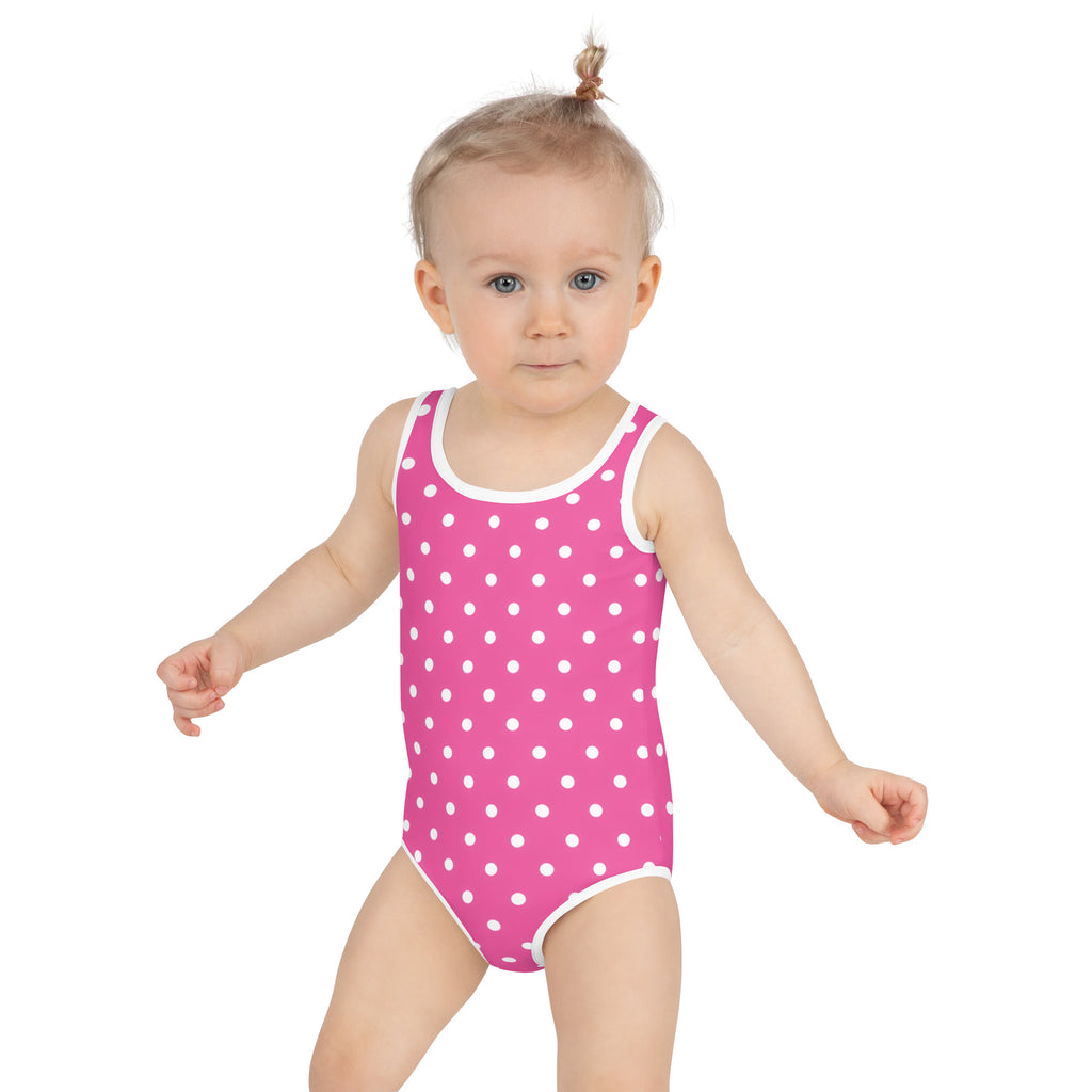 Girls pink one-piece swimsuit with white polka dots and trim made of buttery soft fabric with UPF 50 plus protection