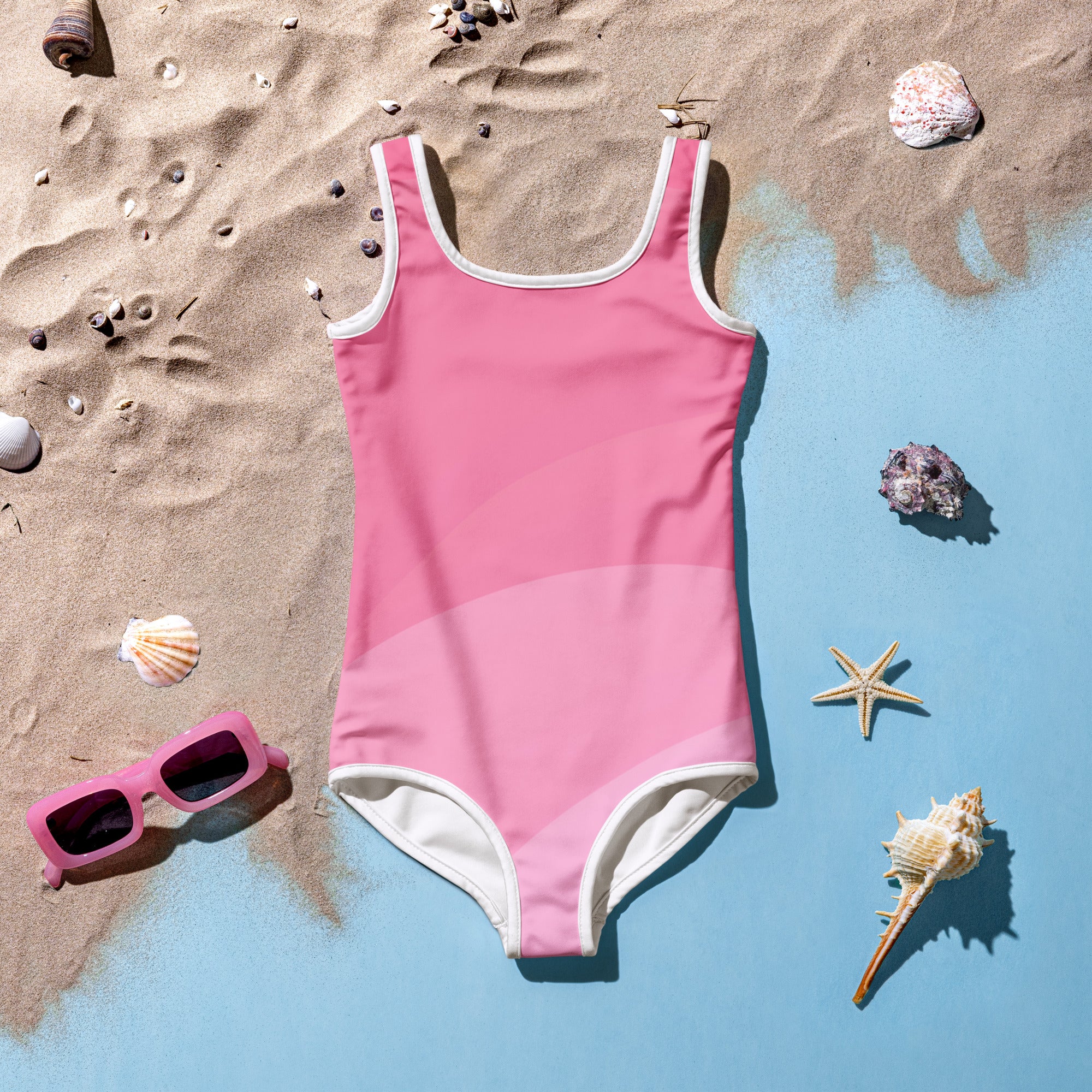 Girls wavy pink one-piece swimsuit with white trim around neckline armholes and leg openings for swimming
