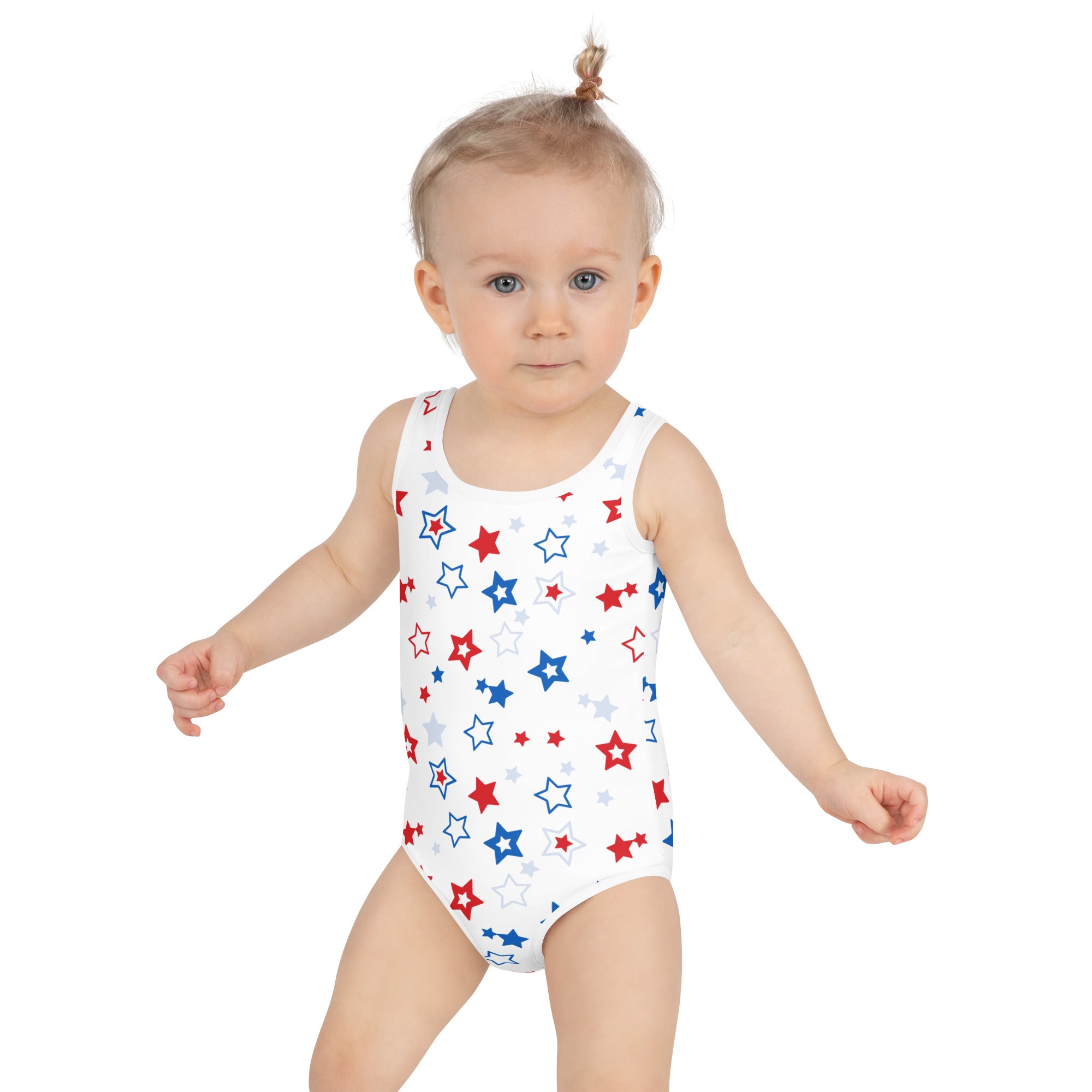 White one-piece swimsuit for girls featuring a playful red blue and silver star pattern for 4th of july wear
