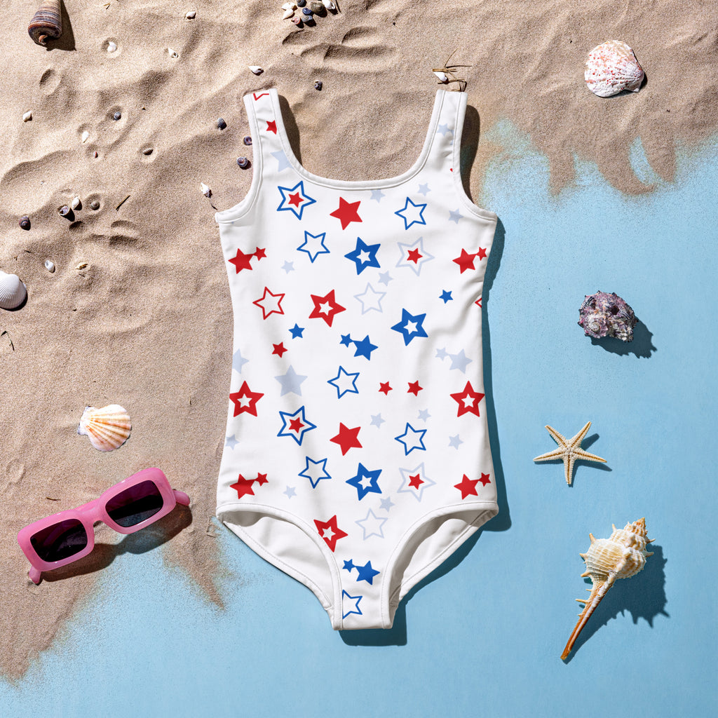 Girls white one-piece swimsuit with red blue and light gray star pattern for 4th of july beachwear