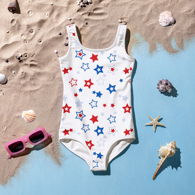 Girls white one-piece swimsuit with red blue and light gray star pattern for 4th of july beachwear