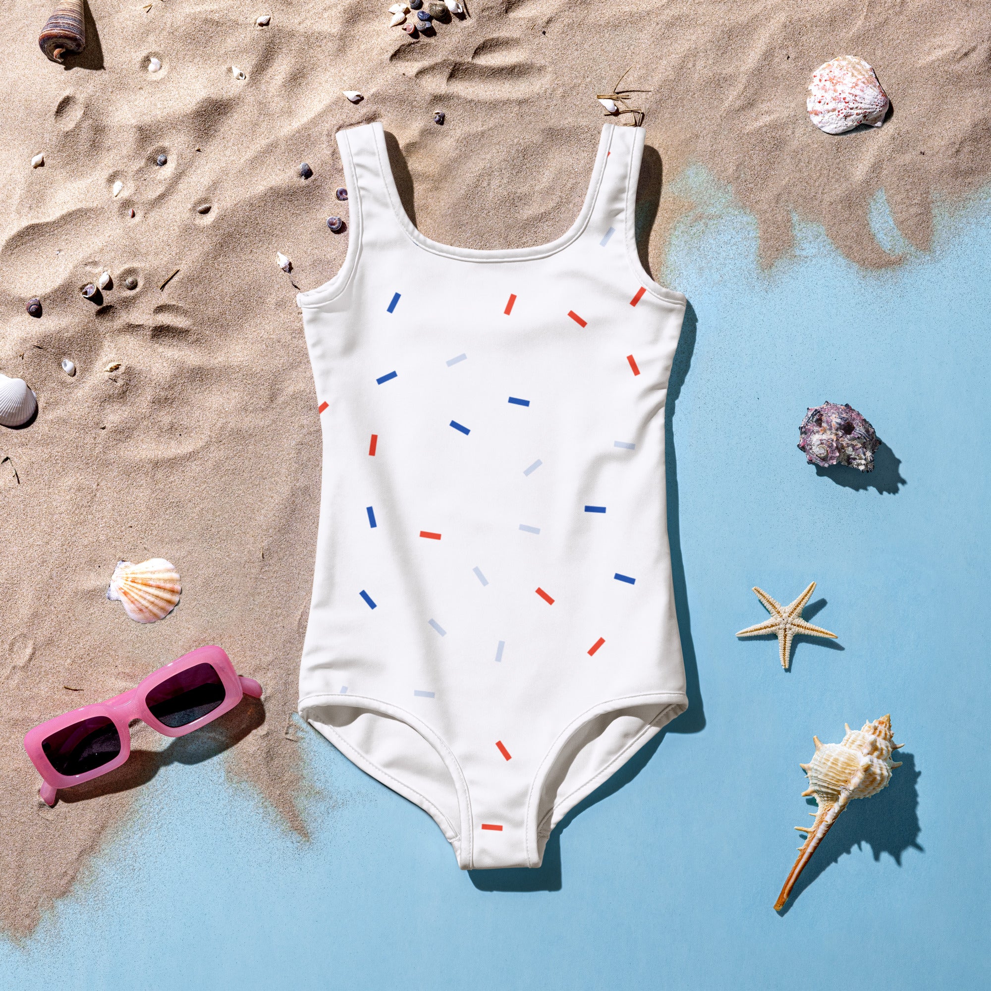 White one-piece girls swimsuit with red blue and light gray vertical stripes for 4th of july celebration
