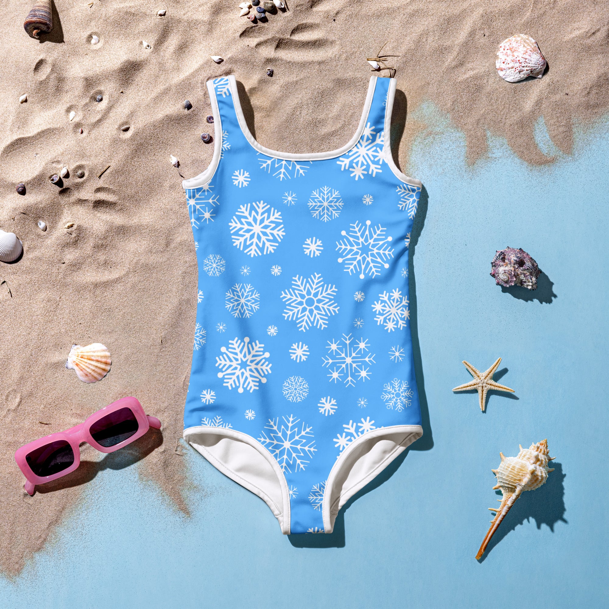 A light blue girls one-piece swimsuit with white snowflake pattern and trim festive holiday swimwear for kids