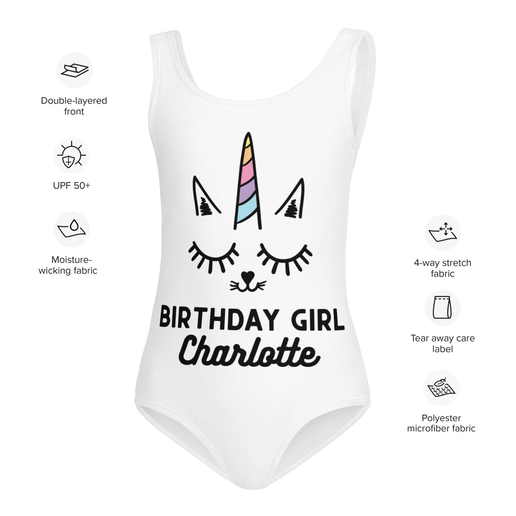 White one-piece swimsuit with cartoon unicorn face and birthday girl charlotte text made of polyester microfiber fabric