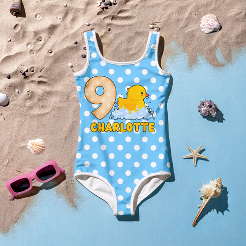 Light blue polka dot one-piece swimsuit with yellow rubber duck and number nine for girls birthday celebration