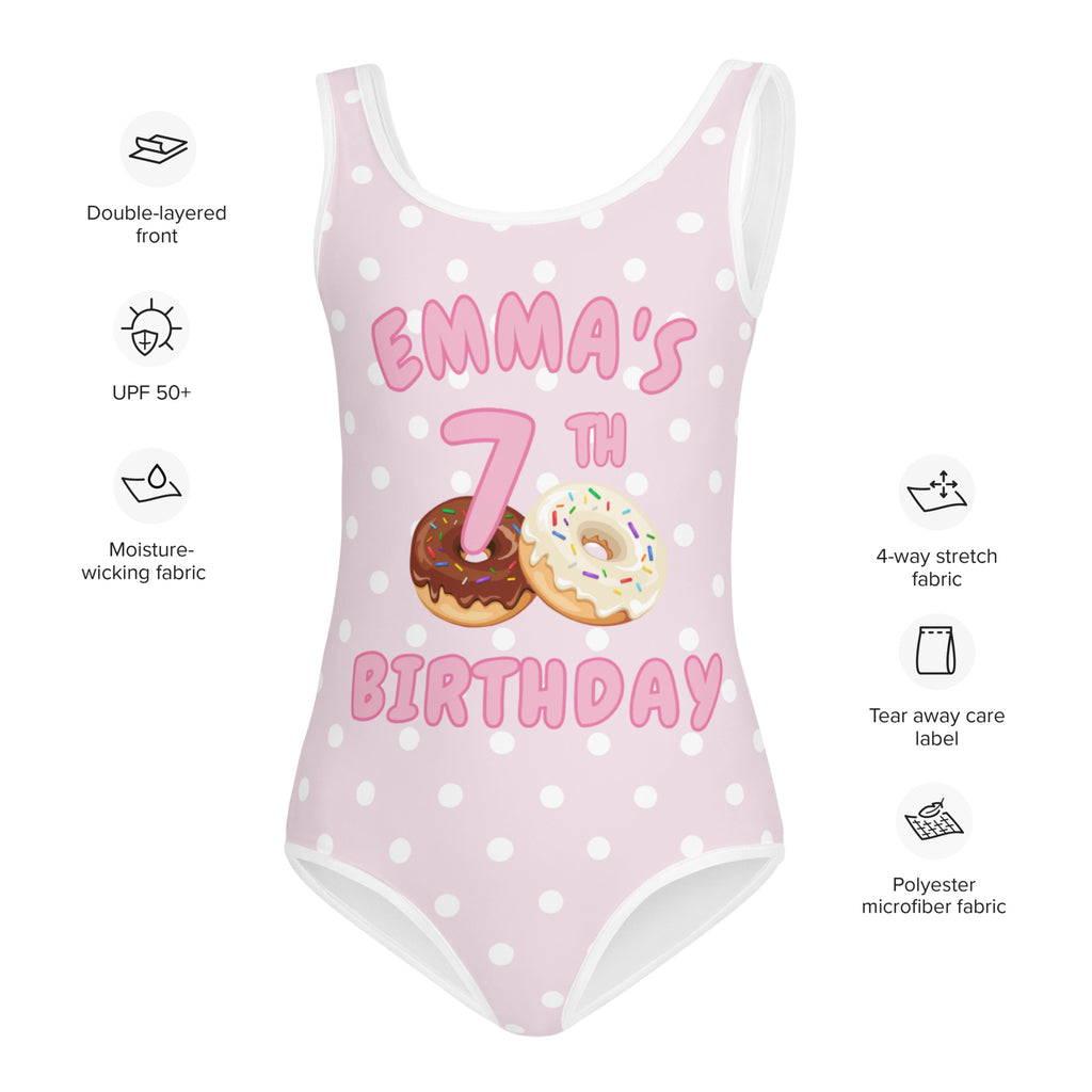 Pink polka-dot girls one-piece swimsuit with emmas 7th birthday and donut custom name and age graphics