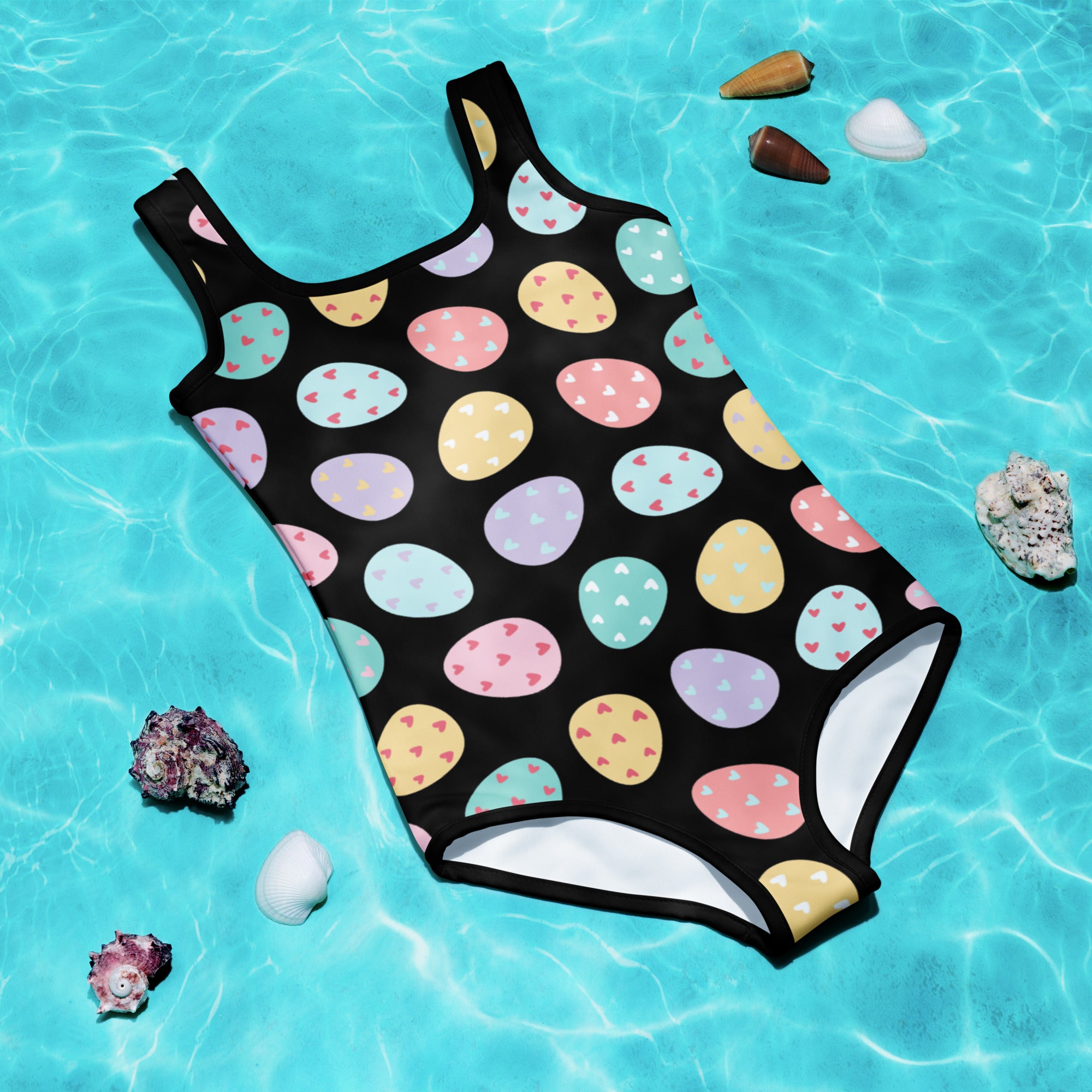 Black one-piece girls swimsuit with colorful pastel easter egg and heart patterns buttery soft fabric upf 50+