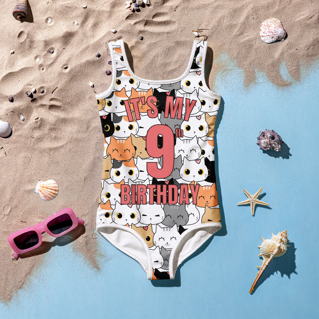 White one-piece girls swimsuit with colorful cartoon cats and pink bold text its my 9th birthday design