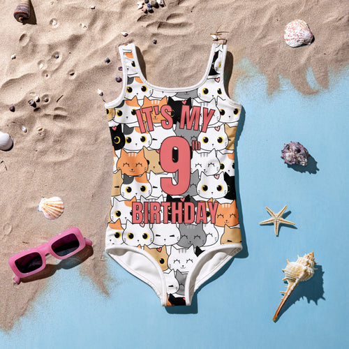 White one-piece girls swimsuit with colorful cartoon cats and pink bold text its my 9th birthday design