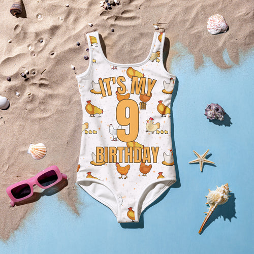 White sleeveless girls one-piece swimsuit with playful chicken and orange its my 9th birthday design