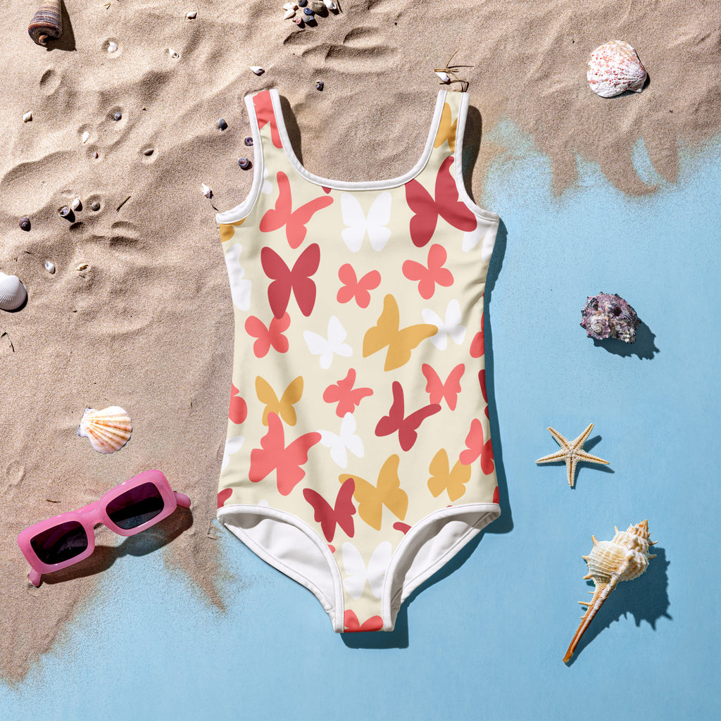 Girls butterfly buttery soft swimsuit with upf 50 plus featuring a vibrant cream coral and yellow butterfly pattern with white trim