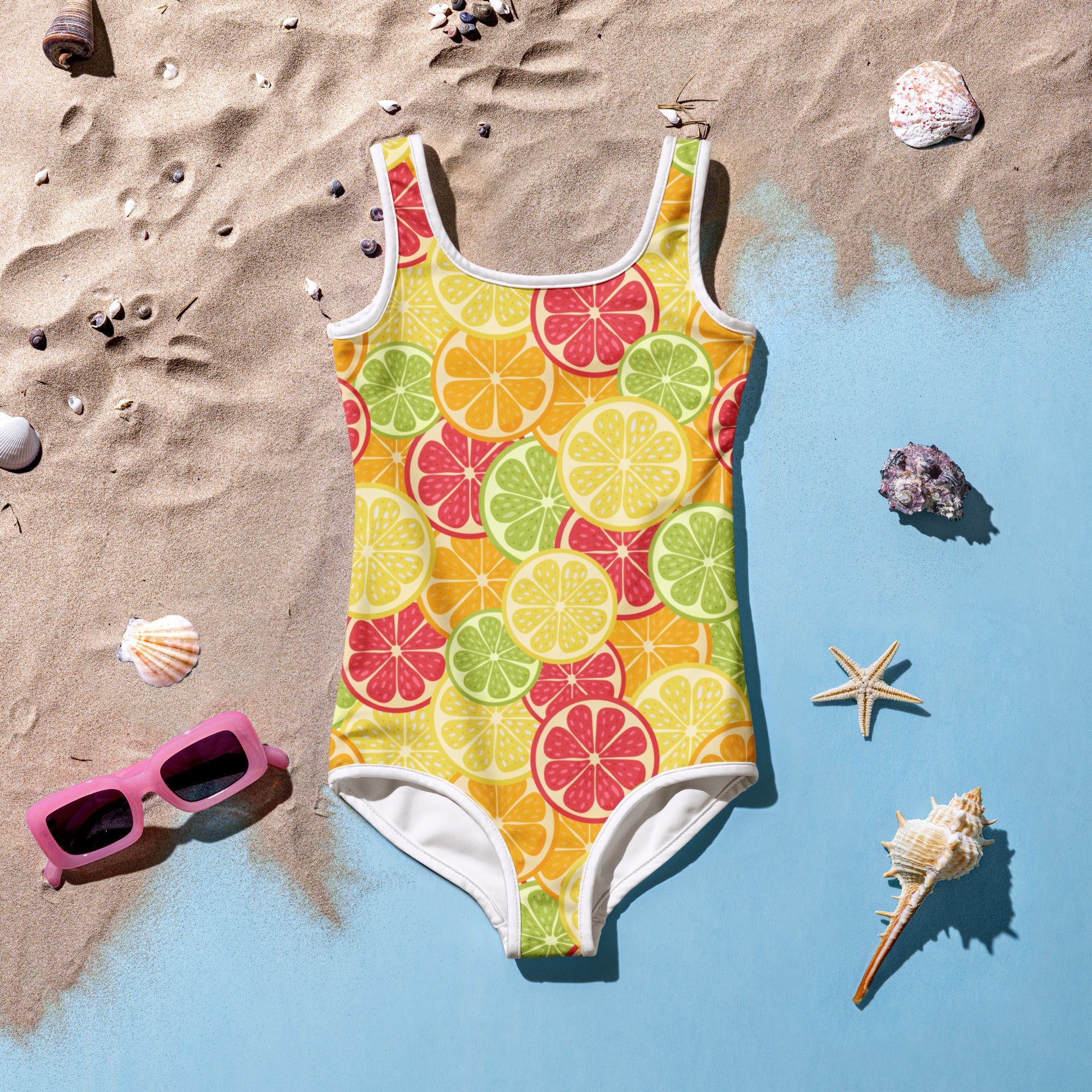 A vibrant yellow girls tropical citrus fruit buttery soft swimsuit with sliced citrus pattern and white trim with UPF 50+