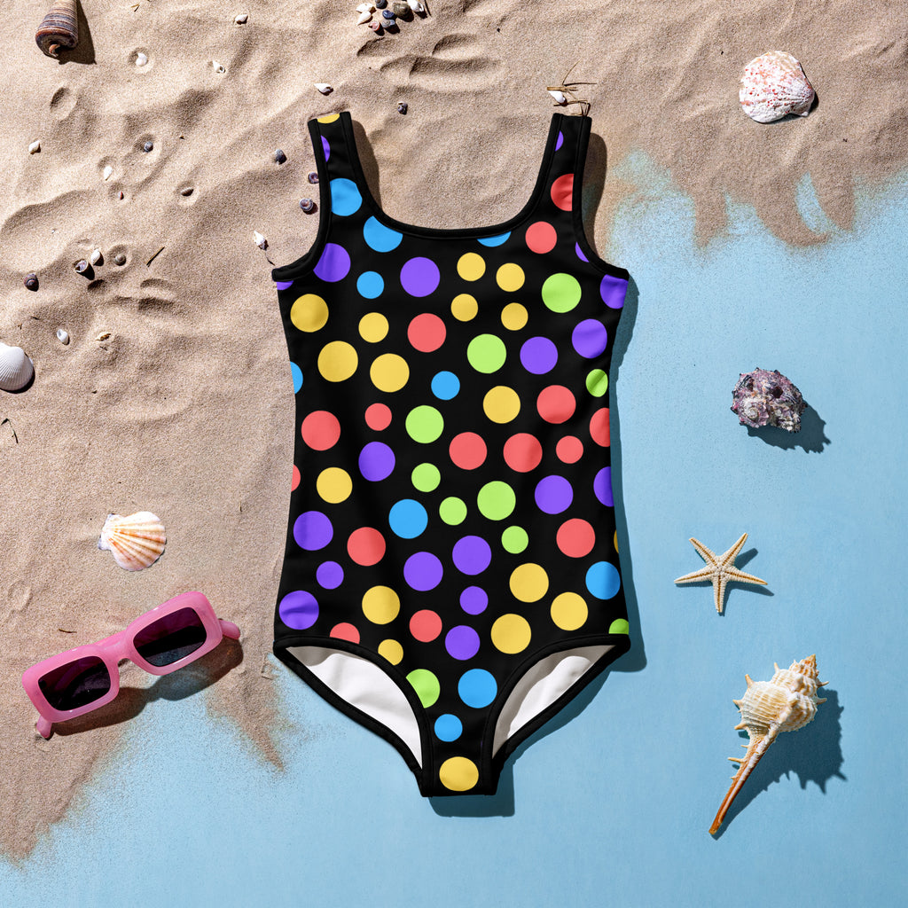 A vibrant black girls one-piece swimsuit with multicolored polka dots made of buttery soft fabric with upf 50+