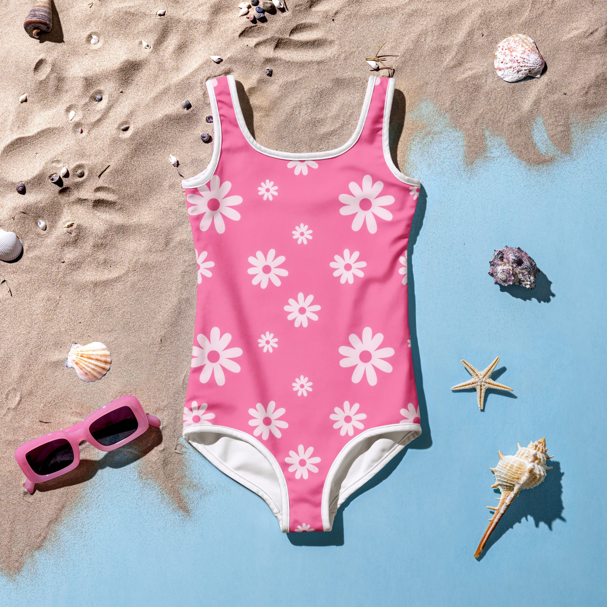 Girls pink daisy buttery soft swimsuit with white trim and UPF 50 plus sun protection in a one-piece design