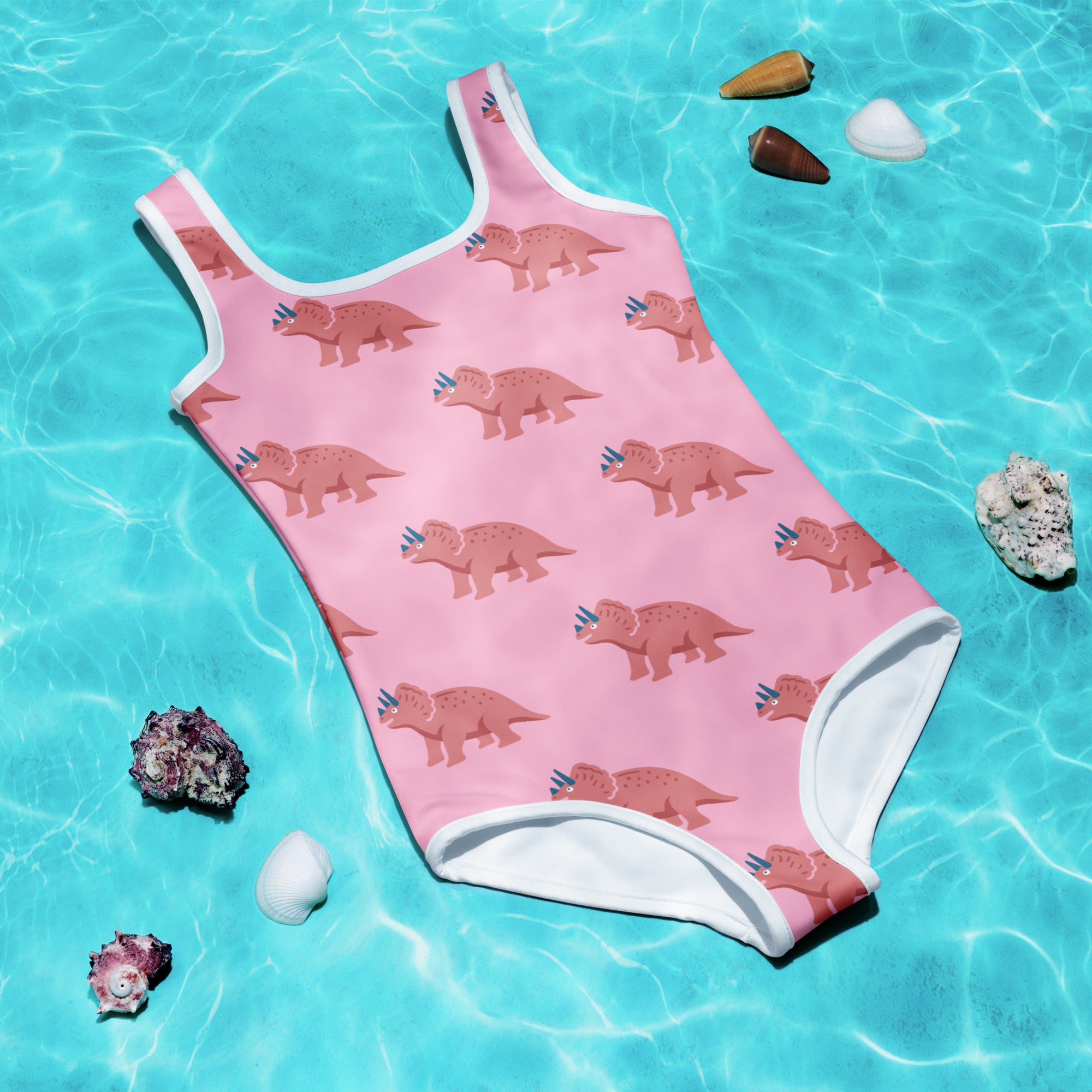 Girls pink buttery soft swimsuit with brown triceratops pattern white trim and UPF 50 plus sun protection