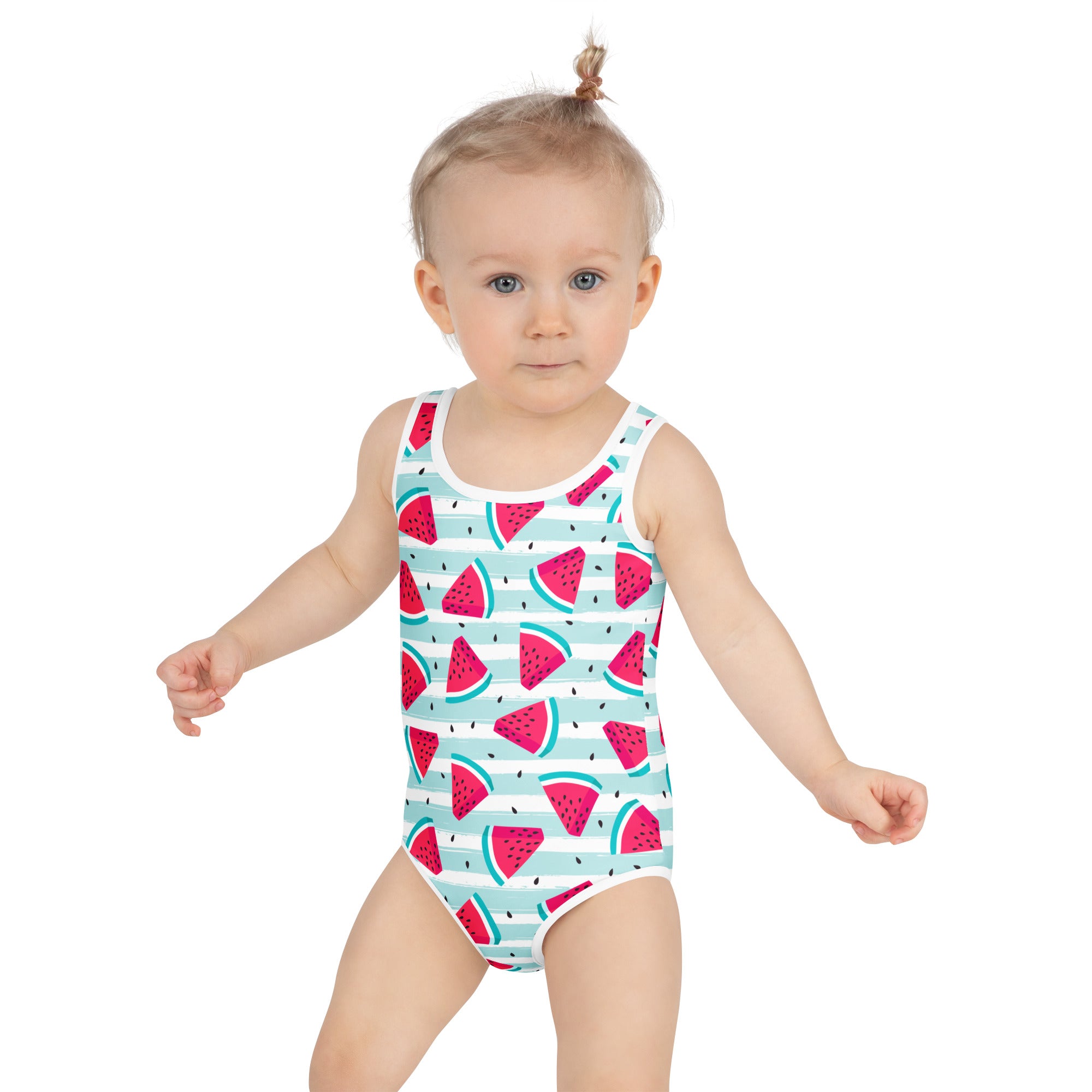 A toddler wearing a girls striped watermelon buttery soft white swimsuit with pink slices and UPF 50+ protection