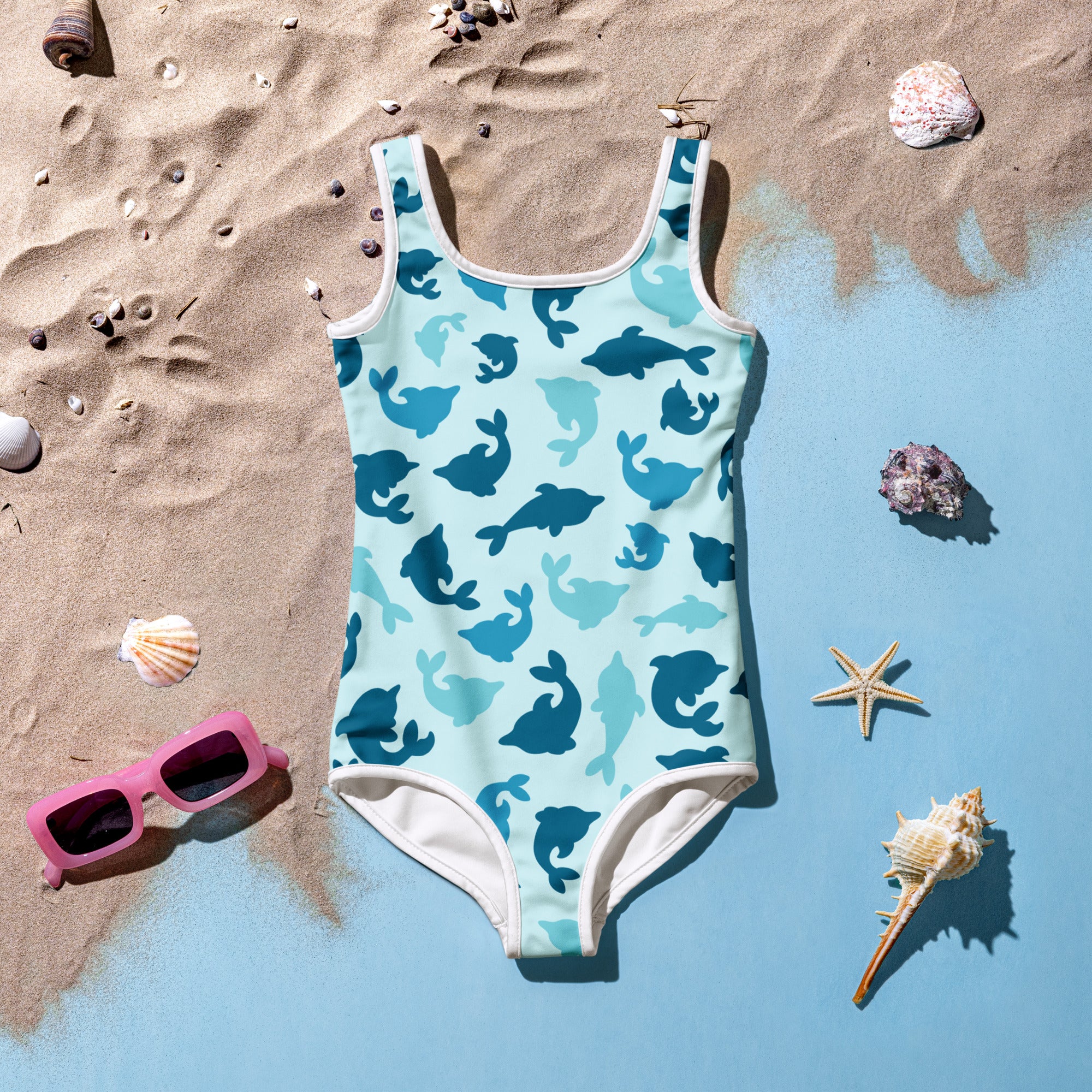 Girls blue dolphin buttery soft one-piece swimsuit with upf 50 plus and white trim featuring navy and teal dolphins