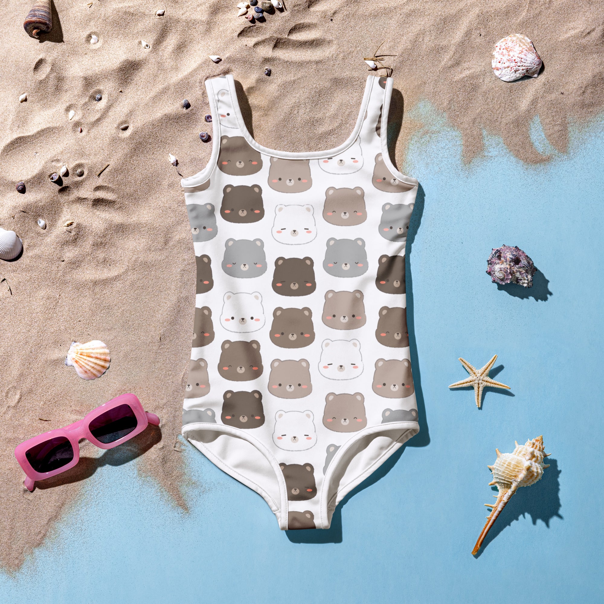 A white girls one-piece swimsuit with kawaii brown and gray bear faces pattern and buttery soft fabric with UPF 50+ protection