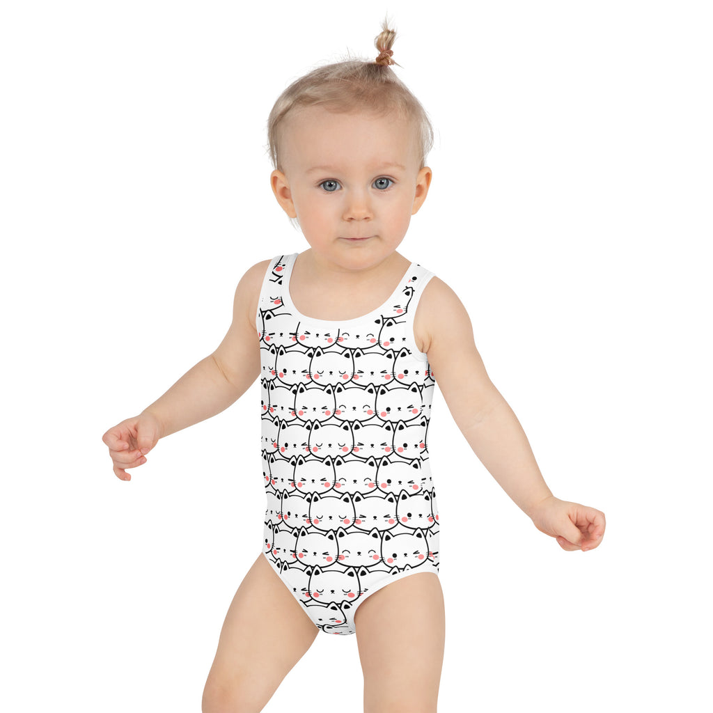 White one-piece girls swimsuit with playful black-outlined cats pink blush cheeks buttery soft fabric upf 50+ protection