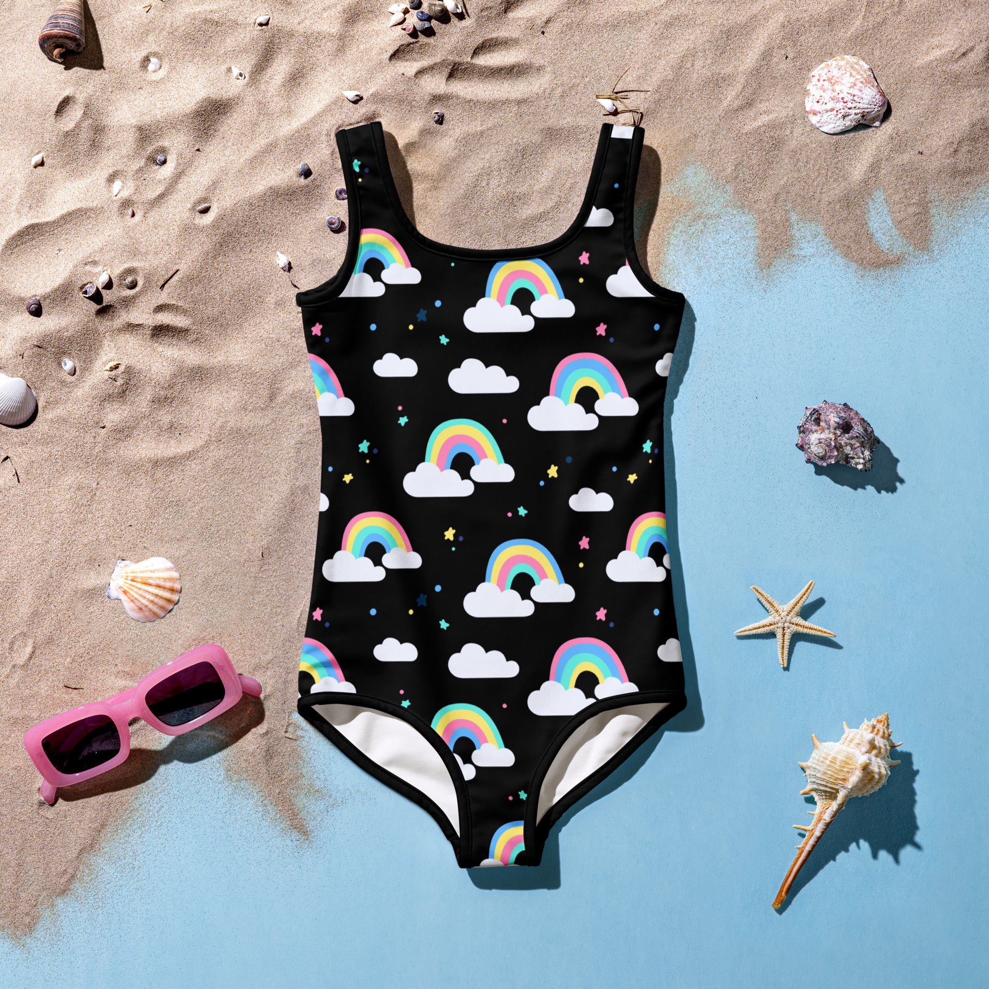 Black girls one-piece swimsuit with playful rainbow cloud pattern white trim buttery soft fabric upf 50+
