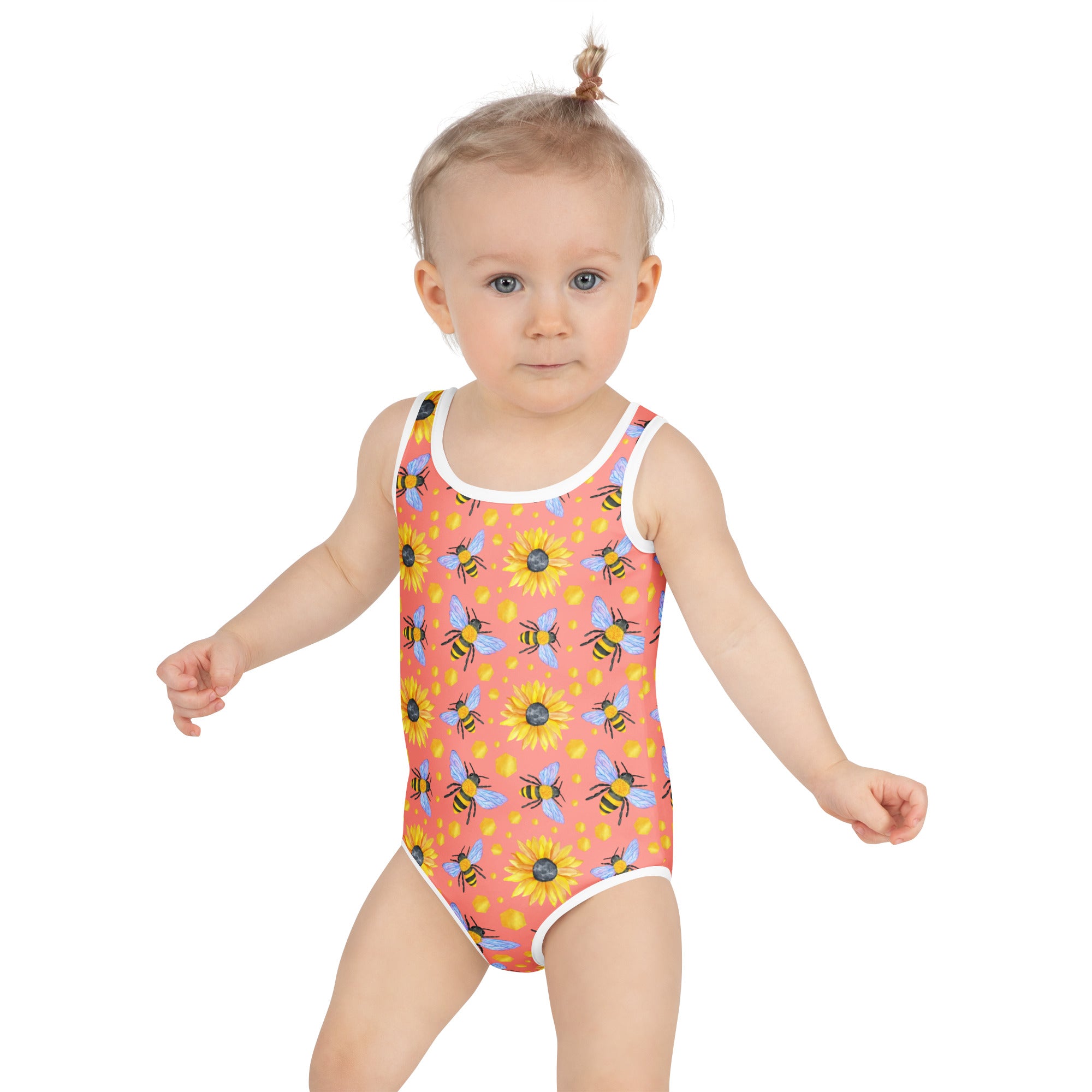 A coral-colored girls bee and sunflower one-piece buttery soft swimsuit with white trim and UPF 50+ sun protection