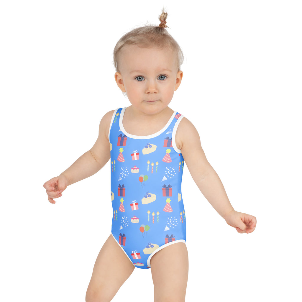 Girls blue buttery soft birthday party swimsuit with white trim festive cakes gifts candles confetti and UPF 50+