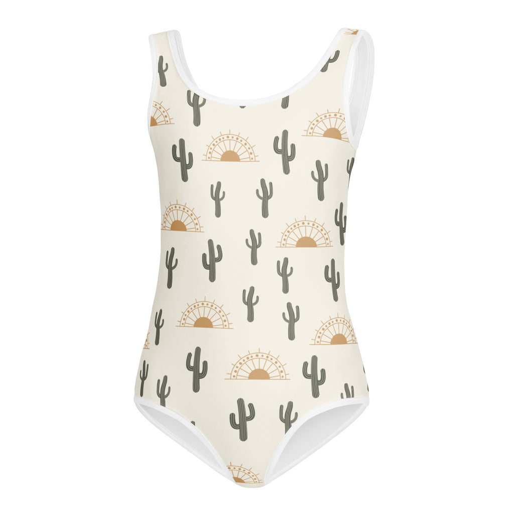 Cream-colored buttery soft girls leotard with dark green cacti and golden sunsets pattern for dance and gymnastics