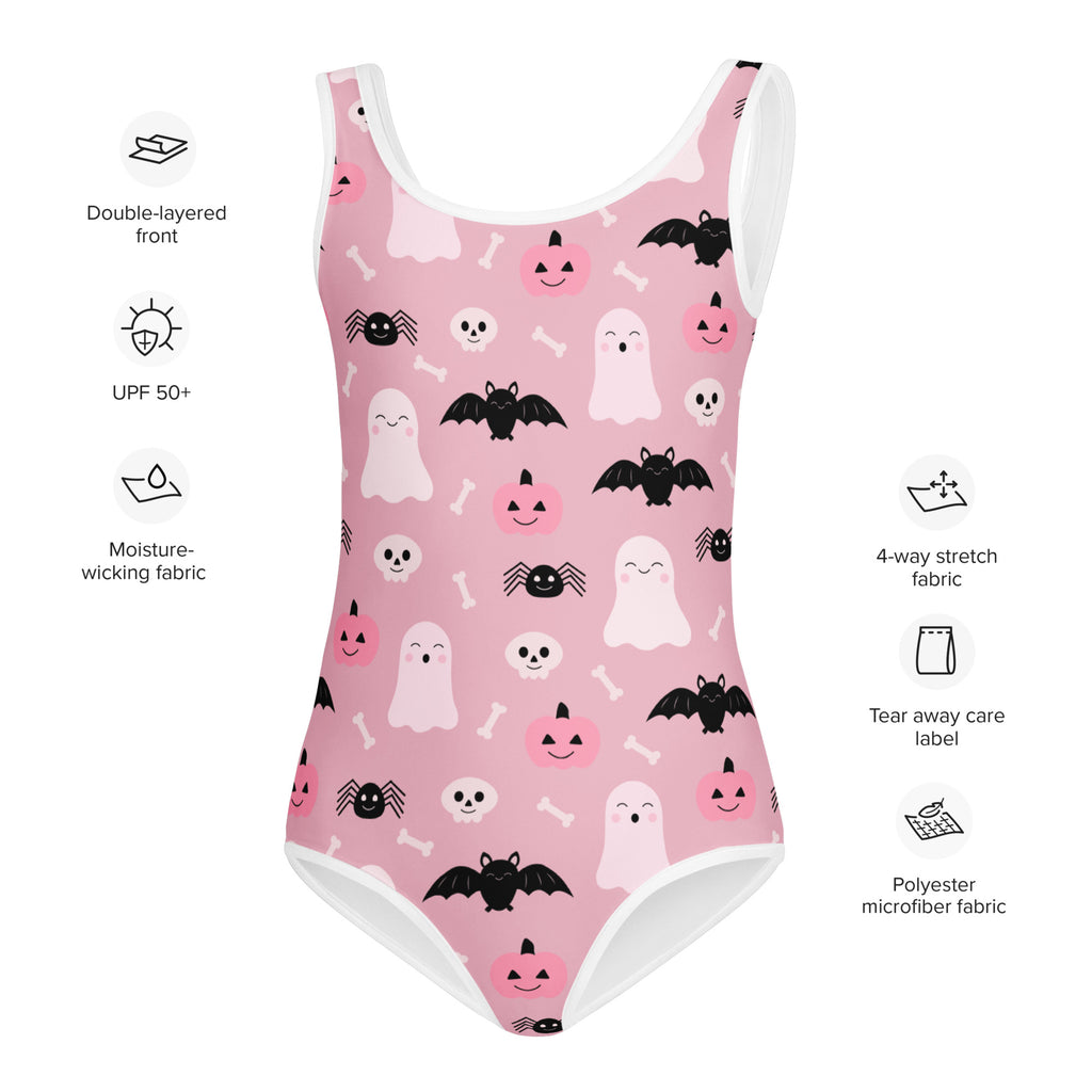 Girls pink Halloween-themed one-piece swimsuit with white trim and black and white ghosts bats pumpkins and spiders