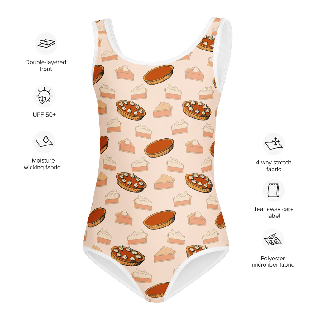 A peach-colored girls one-piece swimsuit with playful pie patterns in orange brown and cream quick drying for dance and gymnastics