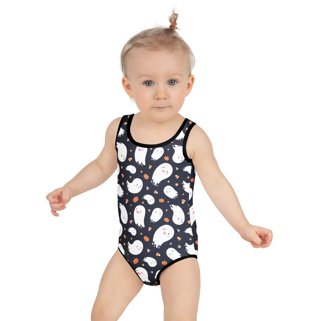 Black one-piece girls swimsuit featuring white cartoon ghosts and orange pumpkin accents for Halloween use