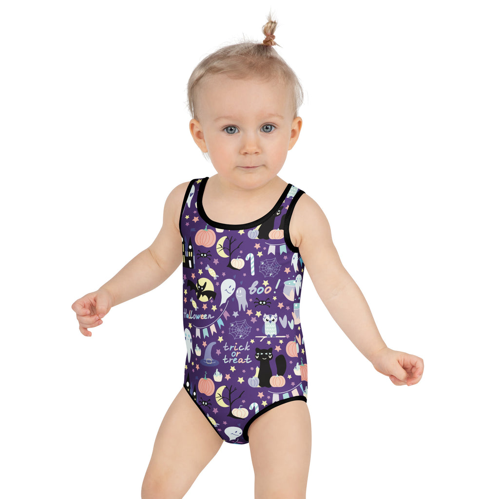 Girls spooky halloween buttery soft swimsuit in purple with black trim and playful pumpkin ghost bat and cat graphics