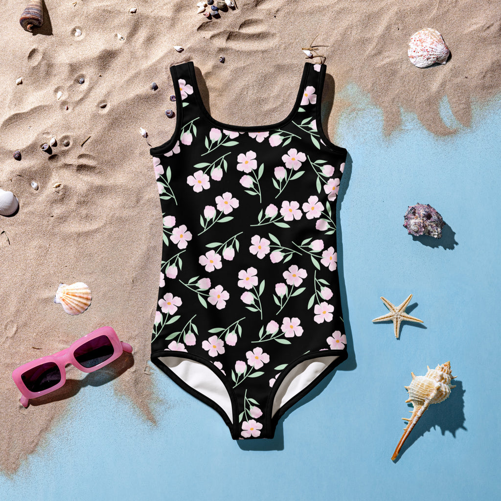 Girls pink flower buttery soft swimsuit with UPF 50 plus in black with pink flowers green stems and white bottom lining