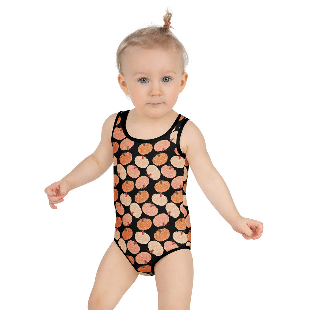 Black one-piece girls swimsuit with buttery soft fabric and playful orange and beige pumpkins pattern and upf 50+ protection
