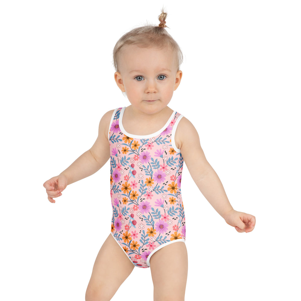 Girls pink floral buttery soft one-piece swimsuit with upf 50+ featuring white trim and colorful flower pattern