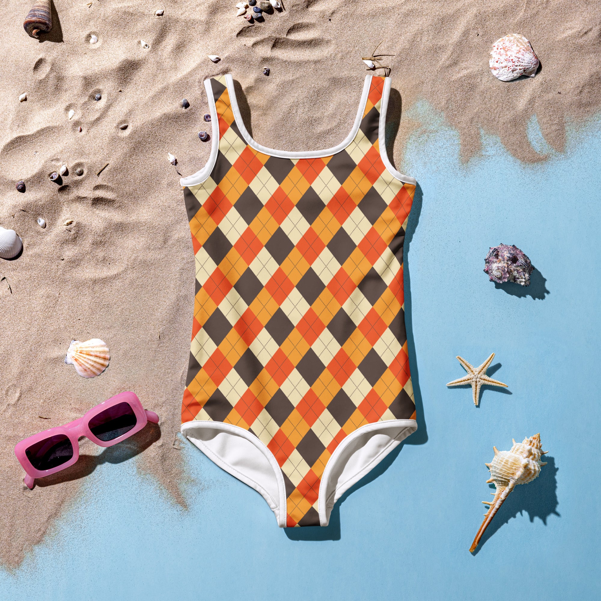 A vibrant orange and brown argyle one-piece girls fall swimsuit with buttery soft fabric white trim and UPF 50+ protection