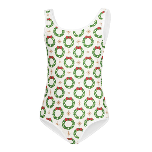 White girls christmas wreath buttery soft one-piece swimsuit with green wreaths red bows and gold starburst accents