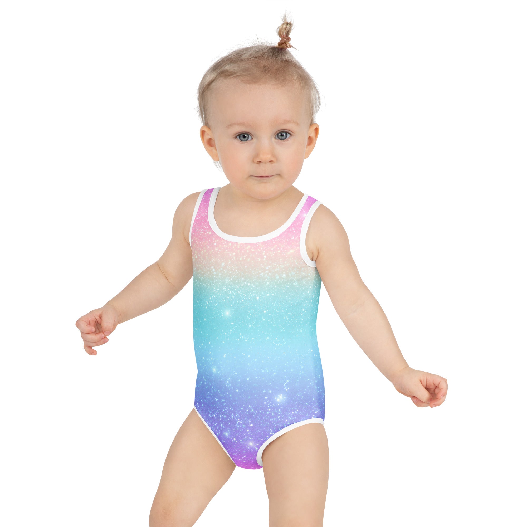 Toddler girl wearing a rainbow faux sparkle effect galaxy print one-piece swimsuit with upf 50+ and white trim