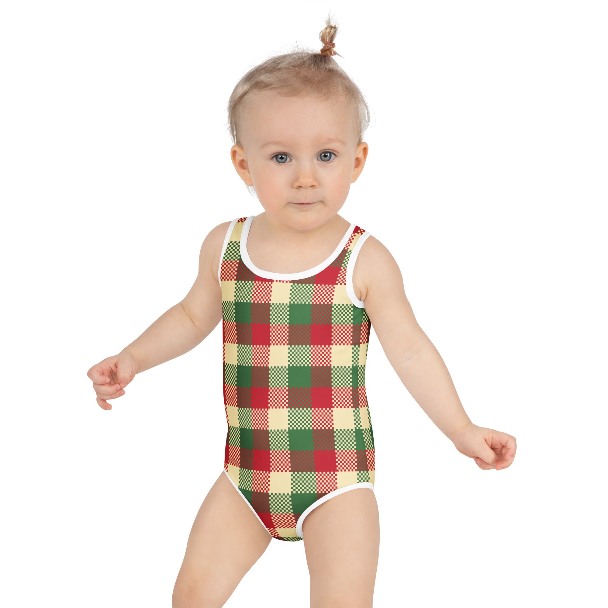 A toddler wearing a girls christmas plaid buttery soft swimsuit in red green and cream with upf 50 plus white trim