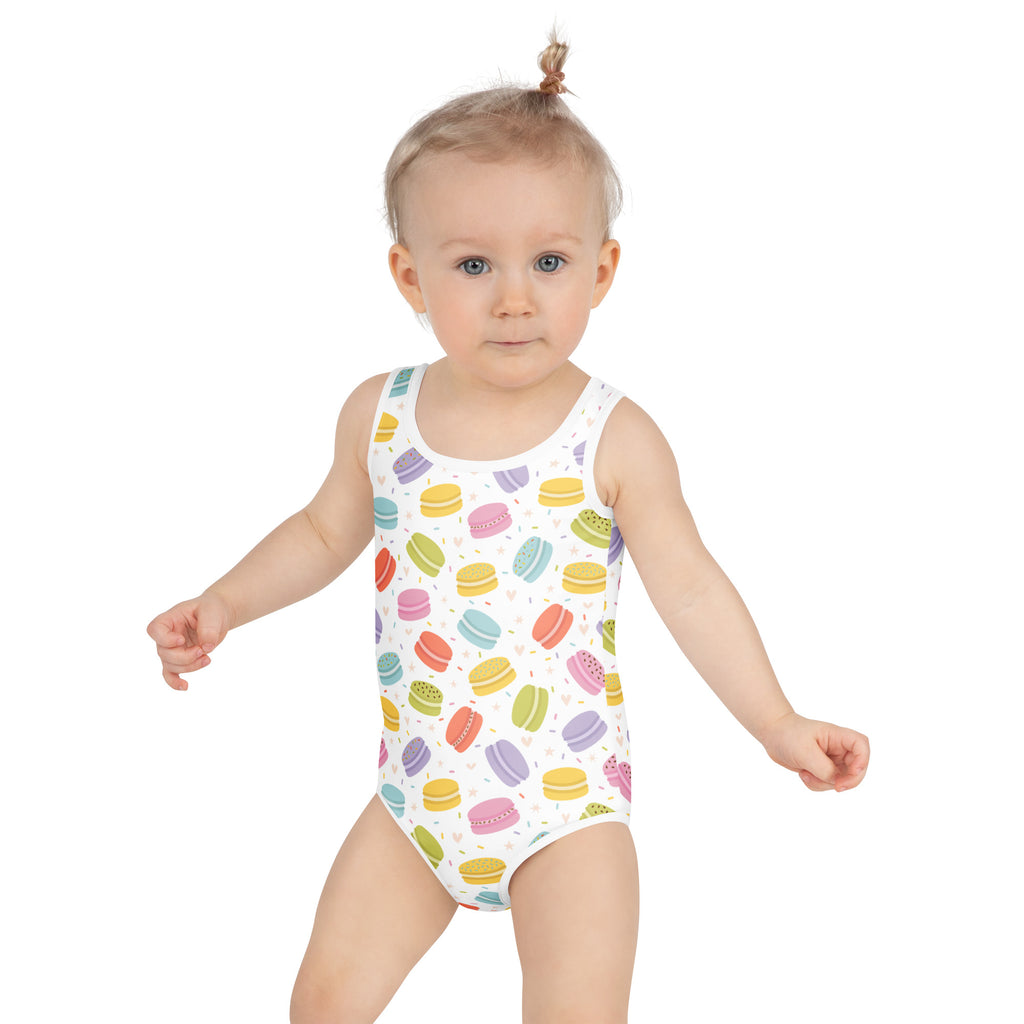 A white girls one-piece swimsuit with colorful pastel macarons pattern buttery soft fabric and upf 50+ protection