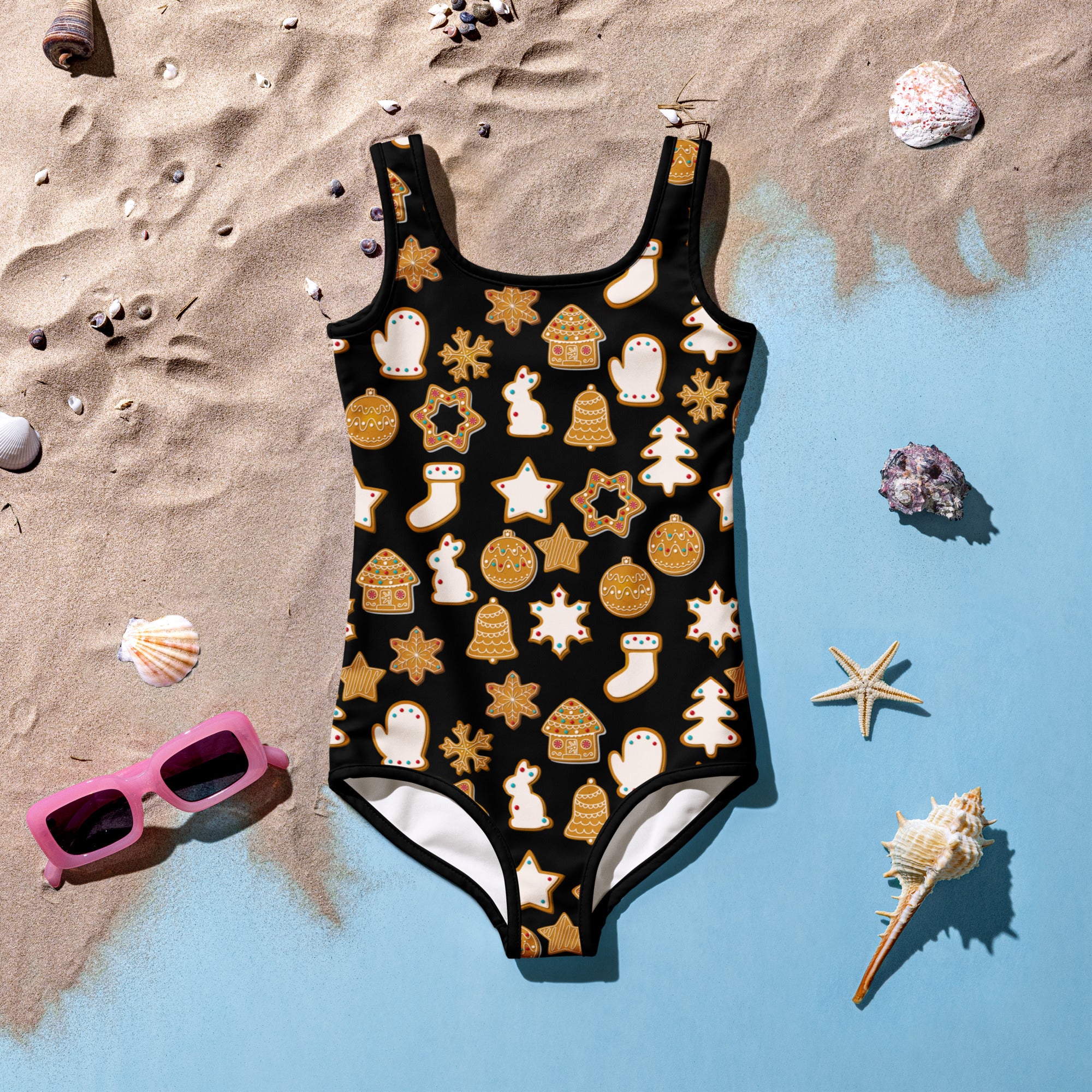 Girls black one-piece swimsuit with buttery soft fabric and festive gold and white gingerbread cookie pattern with UPF 50+