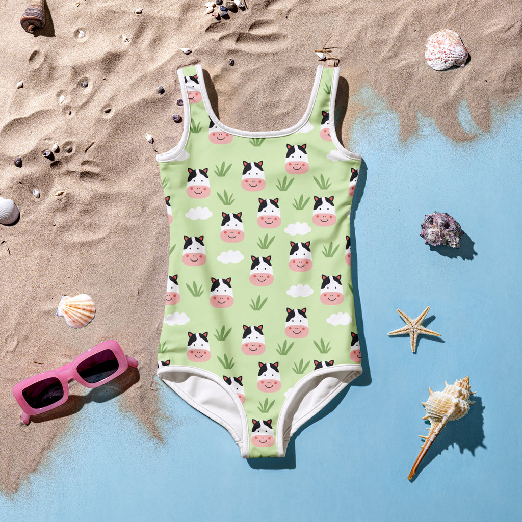 Girls green cow print buttery soft one-piece swimsuit with smiling cows clouds grass pattern and UPF 50+ protection
